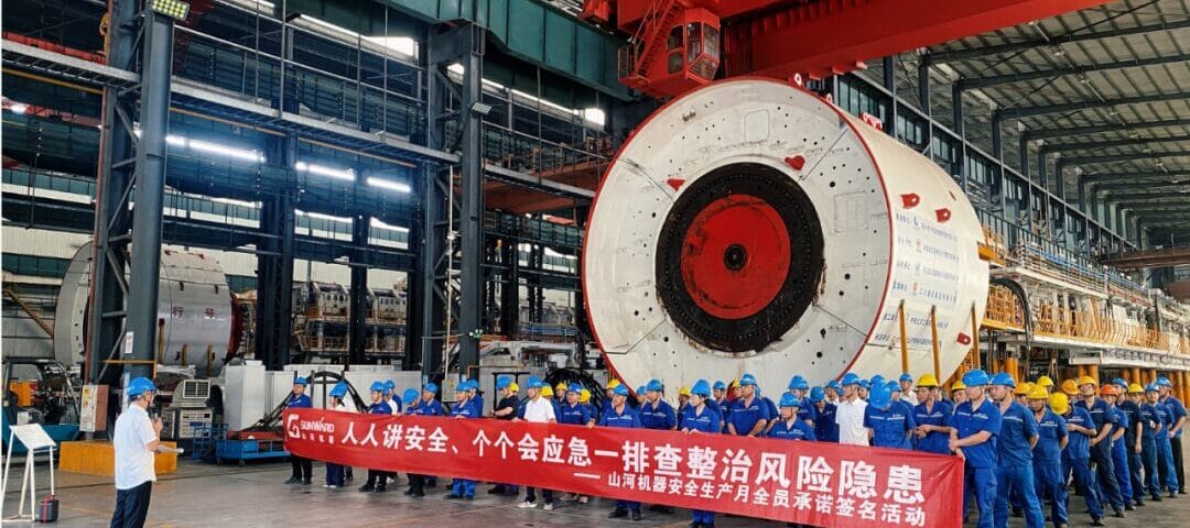 Sunward employees take part in safety production month activities beside shield machine equipment in the workshop