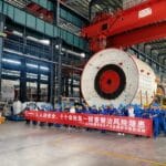 Sunward employees take part in safety production month activities beside shield machine equipment in the workshop